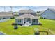 Home featuring a backyard with a patio, outdoor seating, and well-maintained landscaping at 356 Ocean Commons Dr., Surfside Beach, SC 29575