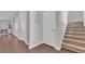 Hallway with hardwood floors, white trim, and access to the carpeted staircase at 356 Ocean Commons Dr., Surfside Beach, SC 29575