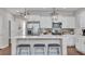 Kitchen island with seating featuring modern lighting and stainless steel appliances at 356 Ocean Commons Dr., Surfside Beach, SC 29575