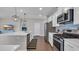 Modern kitchen with stainless steel appliances, white cabinets, and a view into an adjacent room at 356 Ocean Commons Dr., Surfside Beach, SC 29575