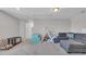 Bright living room featuring a sectional couch, soft carpet, and a ' play area at 356 Ocean Commons Dr., Surfside Beach, SC 29575