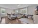 Inviting living room with a large sectional sofa, hardwood floors, and natural light from multiple windows at 356 Ocean Commons Dr., Surfside Beach, SC 29575