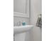 Powder room featuring a stylish pedestal sink with modern faucet and floral hand towel at 356 Ocean Commons Dr., Surfside Beach, SC 29575