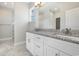 Well-lit bathroom featuring a double vanity with granite countertop, large mirror, and tile flooring at 369 Log Cabin Rd., Loris, SC 29569