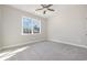 Bright bedroom featuring a ceiling fan, plush carpet, and a window with a view at 369 Log Cabin Rd., Loris, SC 29569