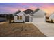 Charming home featuring a two-car garage, and manicured lawn at 369 Log Cabin Rd., Loris, SC 29569
