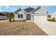 Charming home featuring a two-car garage and beautifully landscaped front yard at 369 Log Cabin Rd., Loris, SC 29569