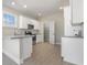 Well-lit kitchen with white cabinetry, granite countertops, stainless steel appliances and convenient pantry access at 369 Log Cabin Rd., Loris, SC 29569
