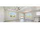Bright living room with plank flooring, ceiling fan, and large windows at 369 Log Cabin Rd., Loris, SC 29569