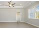 Bright living room with plank flooring, ceiling fan, and large window at 369 Log Cabin Rd., Loris, SC 29569