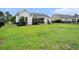 Spacious backyard with lush green grass, trees, and a fire pit area, enclosed by a black fence at 380 Babylon Pine Dr., Myrtle Beach, SC 29579