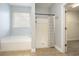 Bathroom features a shower, tub, and tile floors, with a glimpse into the walk-in closet at 380 Babylon Pine Dr., Myrtle Beach, SC 29579