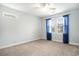Carpeted bedroom featuring a ceiling fan, a window with blue curtains, and neutral-colored walls at 380 Babylon Pine Dr., Myrtle Beach, SC 29579
