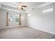 Bright bedroom features a ceiling fan, carpeted floors, and abundant natural light from multiple windows at 380 Babylon Pine Dr., Myrtle Beach, SC 29579