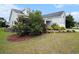 Charming home with landscaped yard and mulched flowerbeds, showcasing curb appeal and mature trees at 380 Babylon Pine Dr., Myrtle Beach, SC 29579
