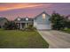 Charming single-Gathering home at sunset, featuring an inviting facade and manicured lawn at 380 Babylon Pine Dr., Myrtle Beach, SC 29579