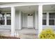 Inviting front porch with white columns, a cozy entrance, and charming decorative accents at 380 Babylon Pine Dr., Myrtle Beach, SC 29579