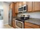 Well-equipped kitchen with stainless steel appliances, granite countertops, and wood cabinetry at 380 Babylon Pine Dr., Myrtle Beach, SC 29579