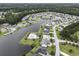 Aerial view of a lakeside community featuring houses, manicured lawns, lush trees, and winding waterfront at 388 Sea Turtle Dr., Myrtle Beach, SC 29588