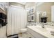Well-lit bathroom featuring a toilet, shower with curtain, vanity and decorative mirror at 388 Sea Turtle Dr., Myrtle Beach, SC 29588