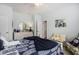Well-lit bedroom with a ceiling fan, window, dresser with round mirror, and coordinated decor at 388 Sea Turtle Dr., Myrtle Beach, SC 29588