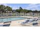 Sparkling community pool with lounge chairs and tables surrounded by palm trees in a fenced-in area at 388 Sea Turtle Dr., Myrtle Beach, SC 29588
