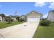 Desirable one-story home featuring a lawn, a palm tree, and an attached two-car garage at 388 Sea Turtle Dr., Myrtle Beach, SC 29588