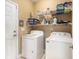 Functional laundry room with a washer, dryer, storage shelves, and a door at 388 Sea Turtle Dr., Myrtle Beach, SC 29588