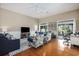 Bright living room with a ceiling fan, a rug, and access to outdoor patio through sliding glass doors at 388 Sea Turtle Dr., Myrtle Beach, SC 29588