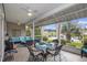 Screened patio with comfortable seating, ceiling fans, dining table and a beautiful waterfront view at 388 Sea Turtle Dr., Myrtle Beach, SC 29588