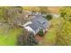 Aerial view of a white house with a gray roof surrounded by trees and a well-maintained yard at 3930 West Marion St., Mullins, SC 29574