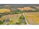 Expansive aerial view of a property surrounded by agricultural fields and mature trees at 3930 West Marion St., Mullins, SC 29574