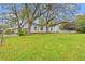 Spacious backyard featuring a patio set, lush lawn, mature trees, and a classic white picket fence at 3930 West Marion St., Mullins, SC 29574