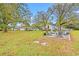 Expansive backyard featuring a seating area, lush green grass, and mature trees, creating a perfect outdoor retreat at 3930 West Marion St., Mullins, SC 29574