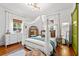 Cozy bedroom featuring a four-poster bed, ample natural light, and hardwood floors, offering a comfortable space at 3930 West Marion St., Mullins, SC 29574