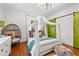 Stylish bedroom featuring a four-poster bed, unique egg chair, and vibrant decor, creating a cozy retreat at 3930 West Marion St., Mullins, SC 29574