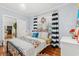 Charming bedroom with hardwood floors, bright natural light, and stylish decor, creating a cozy and inviting space at 3930 West Marion St., Mullins, SC 29574