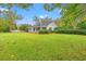 Charming home with a large front yard, white picket fence, and inviting porch, surrounded by mature trees at 3930 West Marion St., Mullins, SC 29574