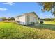 Exterior of a white garage with signage, tables, and equipment, set in a spacious, grassy yard at 3930 West Marion St., Mullins, SC 29574