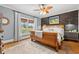 Cozy main bedroom with wood accent wall, large window, and comfortable furnishings, creating a relaxing space at 3930 West Marion St., Mullins, SC 29574
