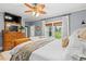 Bright main bedroom with a large window, hardwood floors, and comfortable bedding, perfect for restful nights at 3930 West Marion St., Mullins, SC 29574