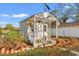 Quaint outbuilding with decorative details, surrounded by potted plants and greenery, adding character to the property at 3930 West Marion St., Mullins, SC 29574