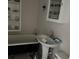 Classic bathroom featuring a clawfoot tub and pedestal sink at 404 E Andrews St., Hemingway, SC 29554