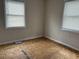 A bedroom with two windows and open space at 404 E Andrews St., Hemingway, SC 29554