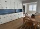 A view of the kitchen with a dining table and adjacent room with a window at 404 E Andrews St., Hemingway, SC 29554