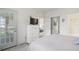 Bright bedroom with access to a balcony, featuring a dresser and closet; bathroom is also visible at 4261 Hibiscus Dr. # 4-104, Little River, SC 29566