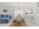 Inviting dining area with a glass table, white chairs, and a view of the living room at 4261 Hibiscus Dr. # 4-104, Little River, SC 29566