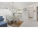 Bright dining area featuring a glass table, six white chairs and white walls and trim at 4261 Hibiscus Dr. # 4-104, Little River, SC 29566