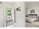 Hallway leading to a bedroom with a bed and gray bedding, and a front door at 4261 Hibiscus Dr. # 4-104, Little River, SC 29566