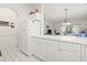 Bright open-concept kitchen with white cabinets and appliances overlooking a living room at 4261 Hibiscus Dr. # 4-104, Little River, SC 29566